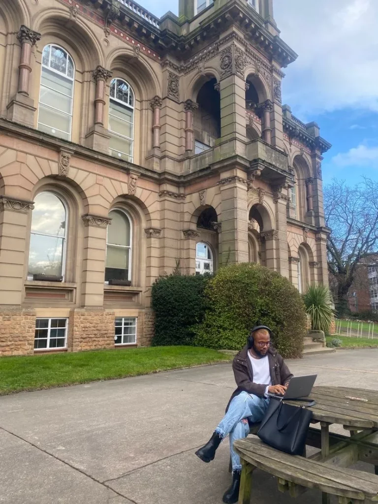 Fashion journalist, Elvis Kawedo in front of Nottingham Trent University for his masters in fashion communication.